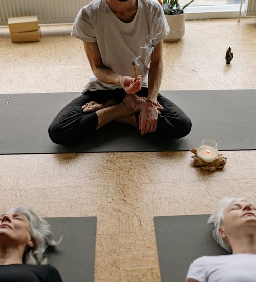 Woman holding a serene yoga pose in a minimalist studio.